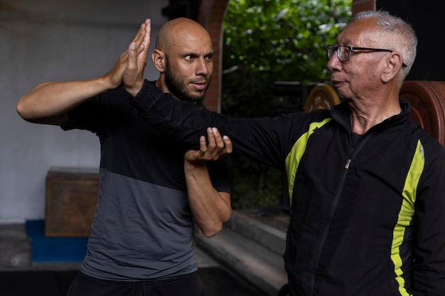 latin american senior male his trainer performing rehabilitation therapy exercises gym healthy lifestyle concept 668440 213