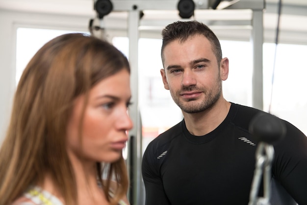personal trainer helping client gym 600776 40106